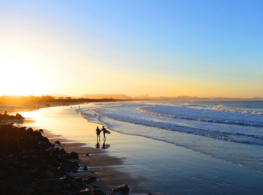 surfers on the beach at Byron Bay